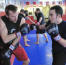 Professor Billy Hendricks practices kickboxing with students